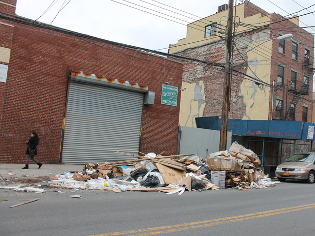 <p>A woman walks past a pile of trash on Van Brunt Street in Red Hook Friday afternoon, Dec. 21, 2012. The trash heap has been growing for weeks following Hurricane Sandy.</p>
