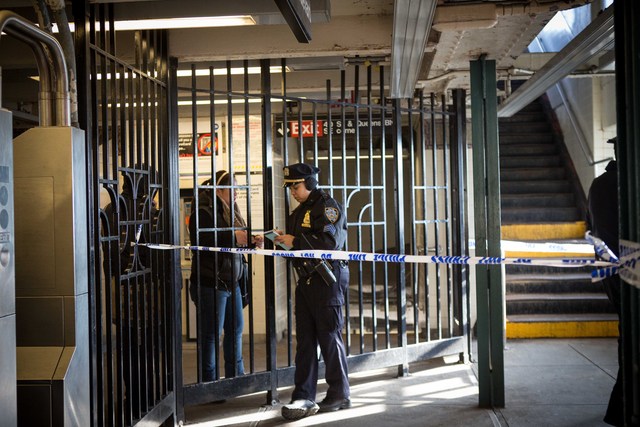 <p>A woman speaks with a police officer at 40th Street Station in Sunnyside Friday morning, Dec. 28, 2012.</p>
