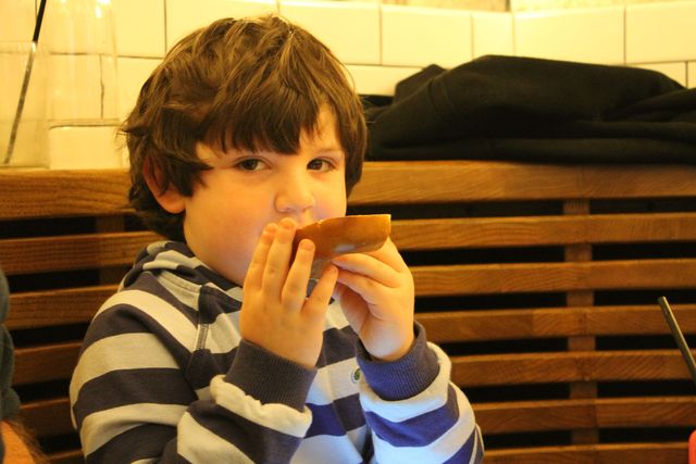 <p>Zach Susel, 4, enjoys a bagel at The Smith.&nbsp;</p>
