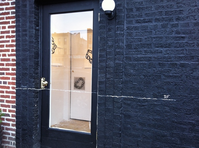 <p>Schmerler painted a line inside the gallery to show how high the floodwater rose in Red Hook during Sandy.</p>
