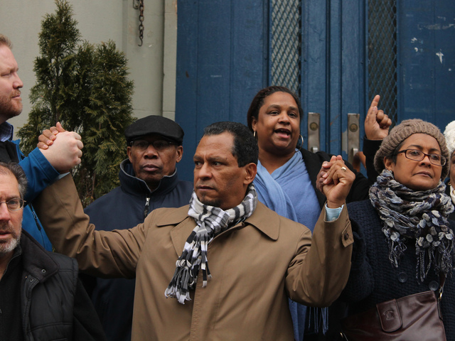 <p>Luis Tejada, who spoke at a rally against the school closing, held hands to show the community's united spirit.</p>
