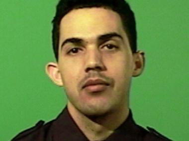 The police officer was shot in the leg, sources said.