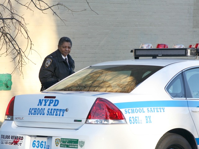 <p>An officer approaches a School Safety cruiser outside the South Bronx Preparatory school, shortly after thefts of five laptops were discovered, on Jan. 7, 2013.</p>
