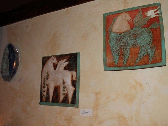 <p>The exhibit shows ceramic wall hangings.</p>
