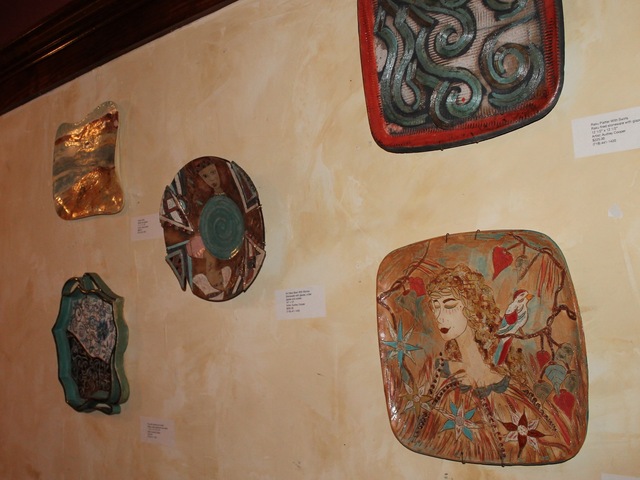 <p>The exhibit shows ceramic wall hangings.</p>
