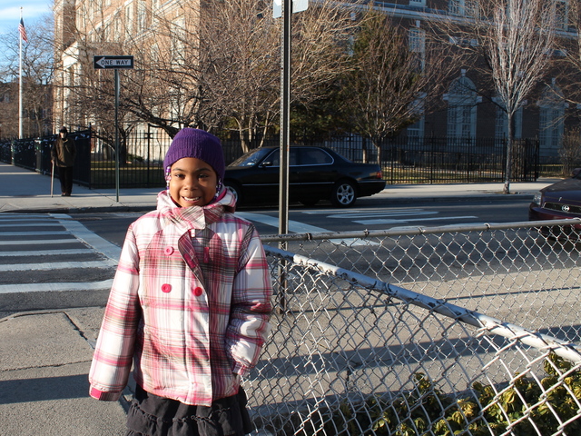 <p>Denim Bailey, 6, outside P.S. 122 in Astoria, where she attends first grade. Mom Tamy Bailey says she loves the school for its diverse student body.</p>
