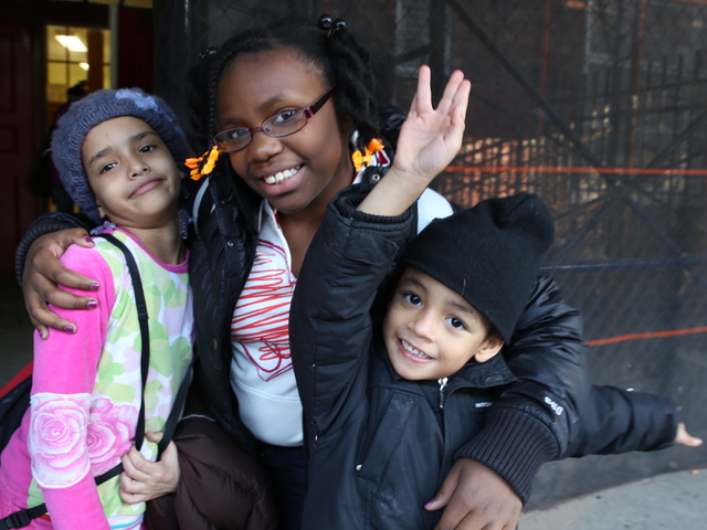 <p>Alexis Mallory, 8, and her brother Lamar, 4, pose for a picture with their friend Shoshana outside of P.S. 67 in Brooklyn.</p>
