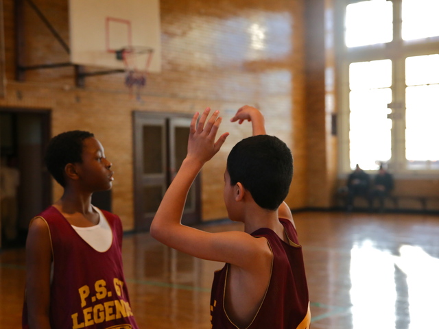 <p>Boys prep for a P.S. 67 basketball game.</p>
