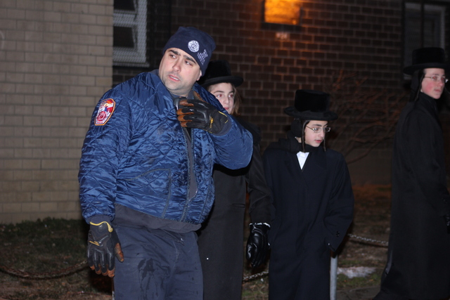 <p>A rescue worker outside a building in Brooklyn where a blaze on January 26, 2013 left a 78-year-old woman, Nelly Bermudez, dead.</p>
