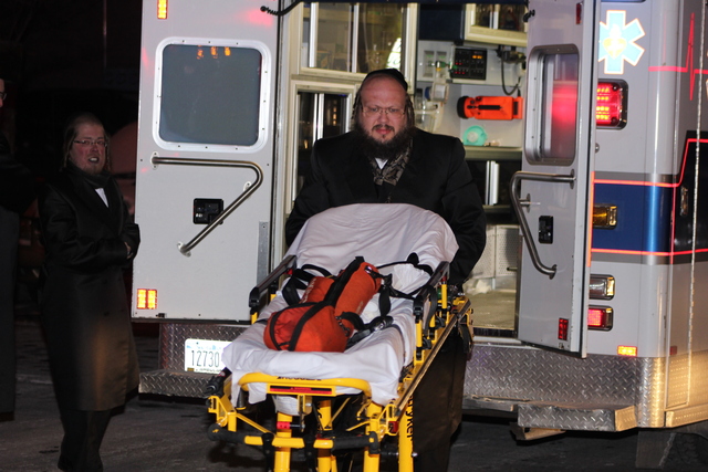 <p>A rescuer wheels an empty gurney from an ambulance at an apartment fire on Ross Street, in Brooklyn, on January 26, 2013.</p>
