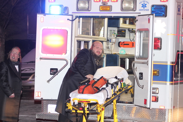 <p>A rescuer wheels an empty gurney from an ambulance at an apartment fire on Ross Street, in Brooklyn, on January 26, 2013.</p>
