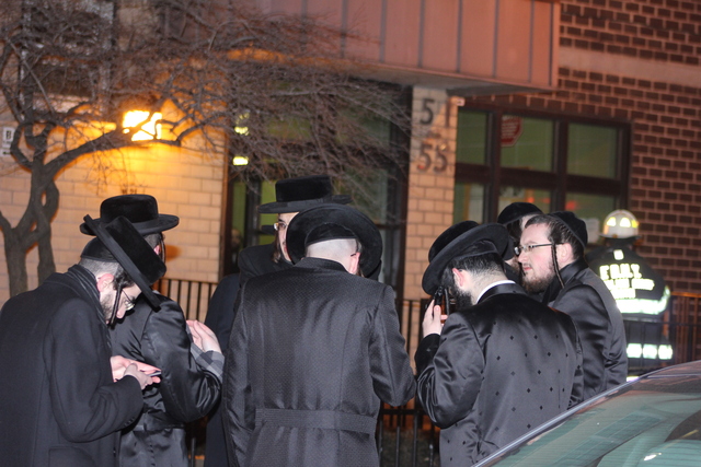 <p>Residents gather outside the apartment building where a blaze on January 26, 2013 left a 78-year-old woman, Nelly Bermudez, dead.</p>
