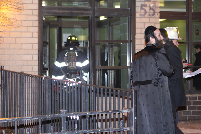 <p>Residents gather outside the Ross Street apartment building in Brooklyn where a blaze on January 26, 2013 left a 78-year-old woman, Nelly Bermudez, dead.</p>

