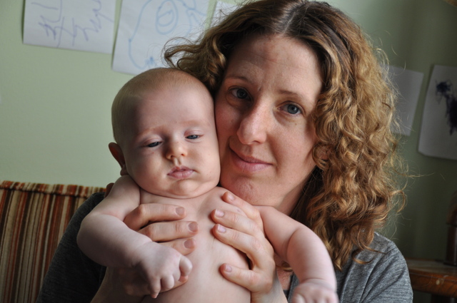 <p>Samantha Huggins held her 2-month-old son Jasper in their living room, where she gave birth to him with a midwife's help.</p>
