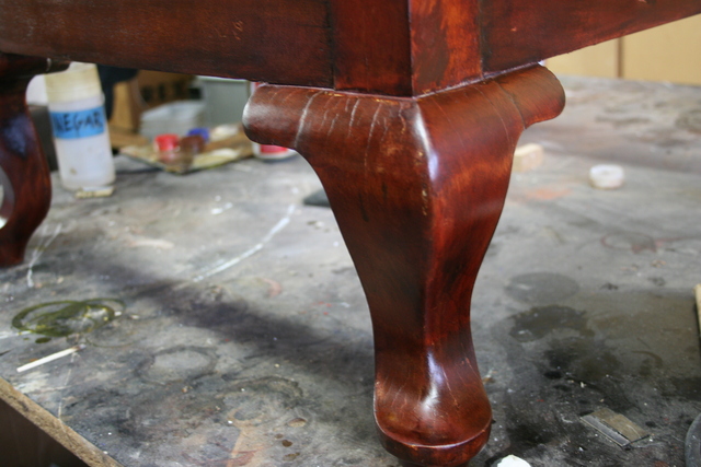 <p>Once the stain is down, go to town with the shellac. This is what brings out the rich shine and depth. Wood has a personality and there's no point in changing it. This chair had a natural reddish hue and zebra pattern.</p>
