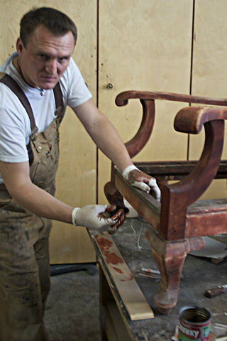 <p>Christopher Anigacz, founder of Double Queue Fine Furniture Restoration and Conservation at work in his Long Island City workshop. With a corner of a clean, white t-shirt, wipe on the stain. Make sure the t-shirt is not dripping wet and whatever you do, DON'T stop moving the wet rag or else the place you stop will be darker than the other areas.</p>
