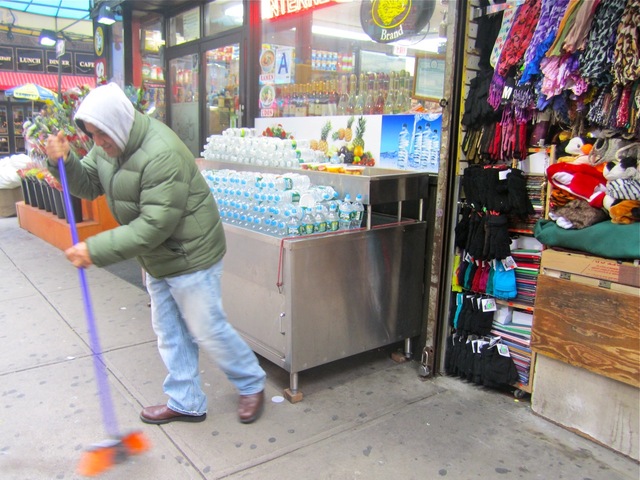<p>Alamgir Hossaen, a worker at a booth on Seventh Avenue that sells scarves, hats and sunglasses, said business was brisk on chilly New Year's Eve Dec. 31, 2012. He cleaned up on New Year's Day 2013.</p>
