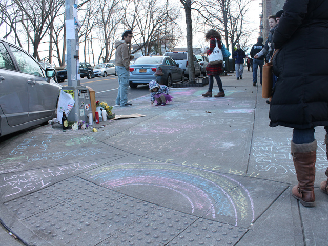 <p>Residents have left messages in chalk on the sidewalk surrounding the shrine.</p>
