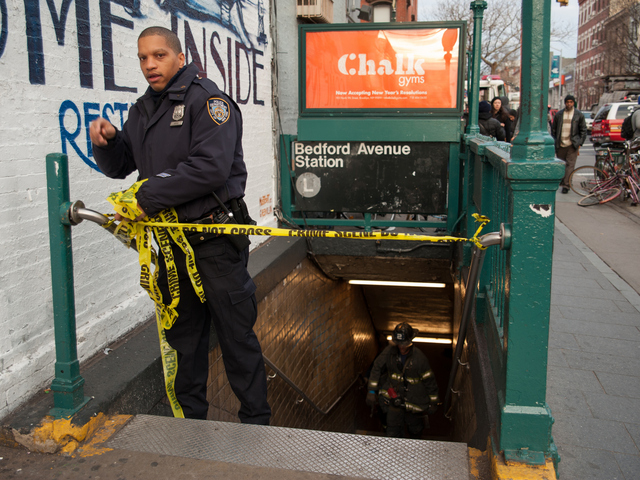 <p>A police officer secures the scene at the Bedford Avenue stop for the L Train, where a woman was struck on Monday Jan. 21, 2013.</p>
