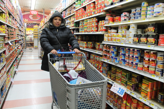 <p>Miriam Vega fills her shopping cart at the Trade Fair on 30th Avenue in Astoria on Feb. 8, 2013. She was waiting for the market&rsquo;s butcher department to re-stock its shelves after it ran out of most meat products before an expected blizzard.</p>

