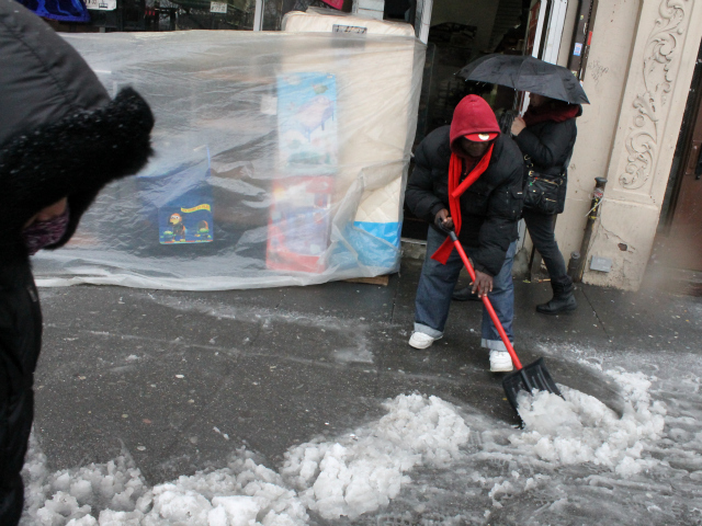 <p>Kofi Acquah cleared the sidewalk outside American Family, a store on E. 149th St.</p>
