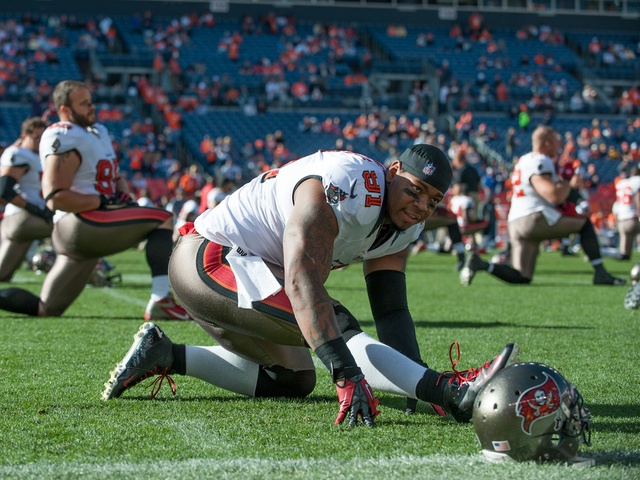 <p>Defensive end Da'Quan Bowers #91 of the Tampa Bay Buccaneers stretches on the field before the game against the Denver Broncos on Dec. 2, 2012 in Denver, Colorado.</p>
