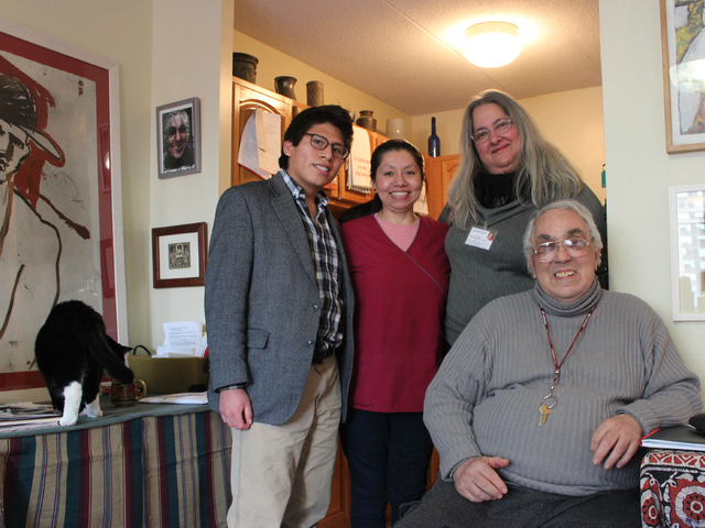 <p>Romero, seated, stands with Alejandro's volunteer caretaker Tony Friedman, Search and Care's Robin Strashun and a medical assistant.</p>
