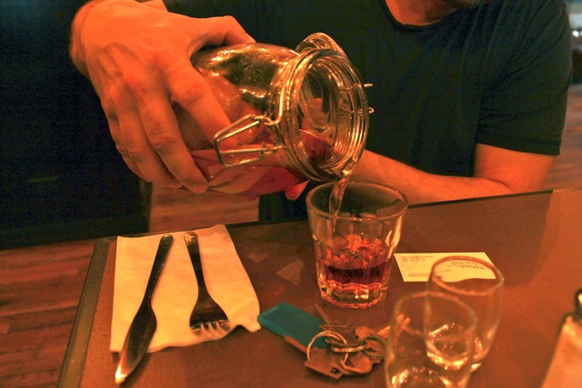 <p>Arnon Magel, 36-year-old owner of Kipsey's, pours a liquor-fruit infusion, which include apple, cinnamon and thyme.</p>
