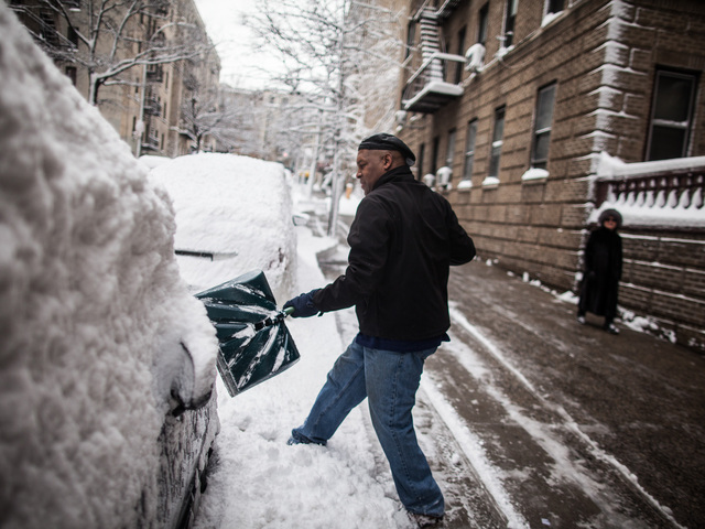 <p>Washington Heights resident Marcos Herbert, 51, digs out his Toyota Previa on Bennett Ave., on Feb. 9, 2013.</p>
