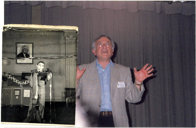 <p>Mel Zweidler stood on stage in J.H.S. 50 next to a photo of him on the same stage as a child.</p>

