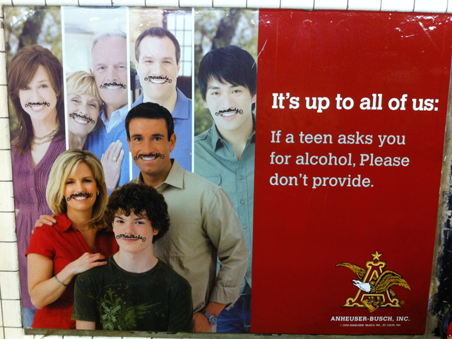 <p>Patrick Waldo tags advertising posters with the word "moustache."</p>
