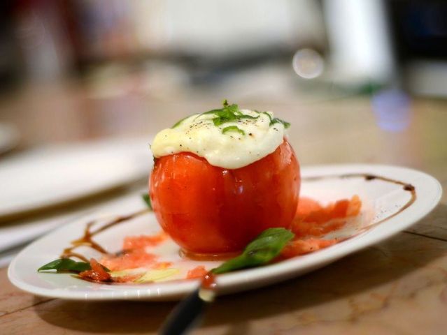 <p>Fresh mozzarella in vine-ripened whole tomato at My Kitchen</p>
