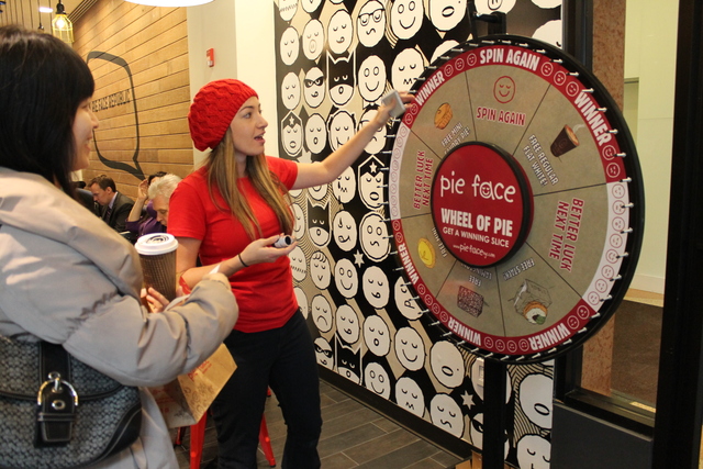 <p>Pie Face brand manager Tennille Scicluna invites a customer to spin a wheel for free prizes Tuesday, Feb. 19, 2013. The giveaway was part of an event celebrating the opening of Pie Face's third Manhattan location on Seventh Avenue.</p>
