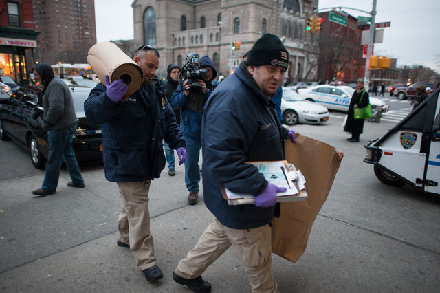 <p>NYPD officers arrived at the 40th Precinct stationhouse Feb. 26, 2013.</p>
