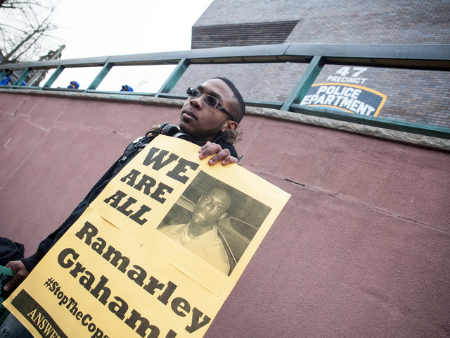 <p>A protester holds up a sign outside the NYPD 47th Precinct during the one-year anniversary rally for Ramarley Graham, in the Bronx on Feb. 2, 2013.</p>
