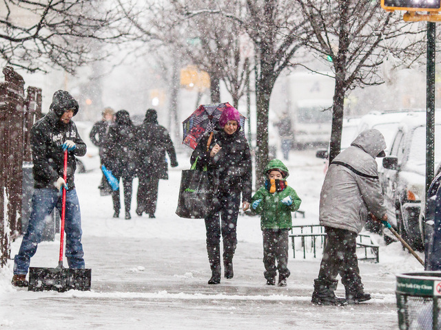 <p>Residents in Washington Heights begin to clear snow and head home before a snowstorm hits New York City on Feb. 8, 2013.</p>
