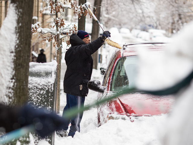 <p>Residents in Washington Heights clear snow from their vehicles after a snow storm hit New York City on Feb. 9, 2013.</p>
