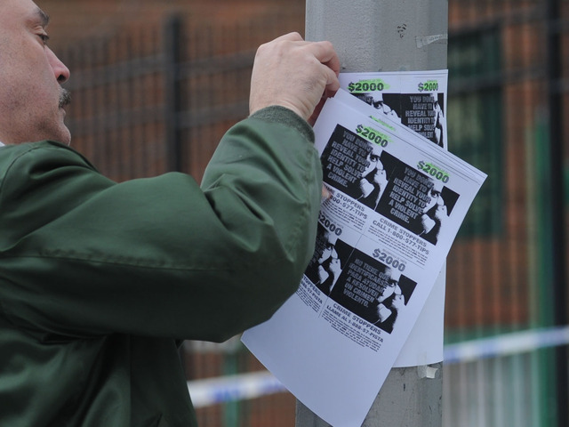 <p><span>Neighborhood volunteer Sidney Flores posts reward fliers on Eagle Avenue in The Bronx. </span></p>
