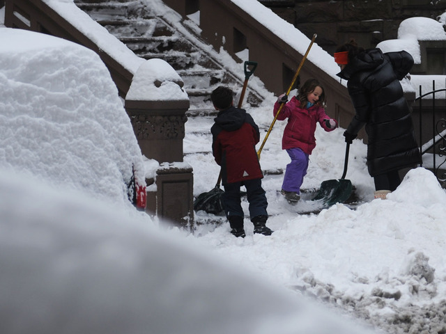 <p>A family uses teamwork to shovel a walkway on West 70th Street on the Upper West Side on Feb. 9, 2013.</p>
