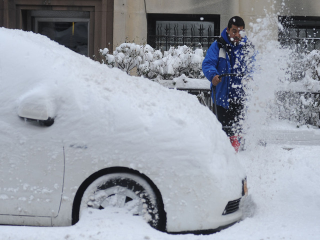 <p>A man uses a snowblower on 70th Street on the Upper West Side on Feb. 9, 2013.</p>
