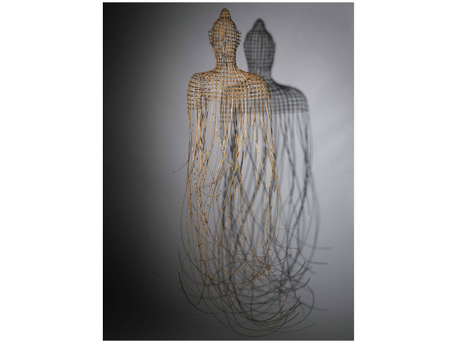 <p>The strand ends of Sopheap Pich's Buddha are red. Pich explained on a museum placard that the image stems from a childhood memory, when he entered a Buddhist temble and found blood splattered everywhere.</p>
