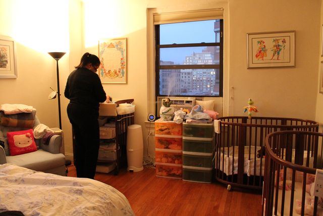 <p>Janet, the Molinari family's nanny, changes one of the twins in the master bedroom.&nbsp;</p>

