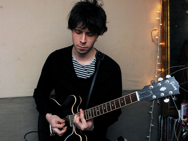 <p>Nathanael "Lefty" Maynard plays guitar with the band VietNam in Greenpoint, Brooklyn before they start their national tour, Feb. 26, 2013.</p>
