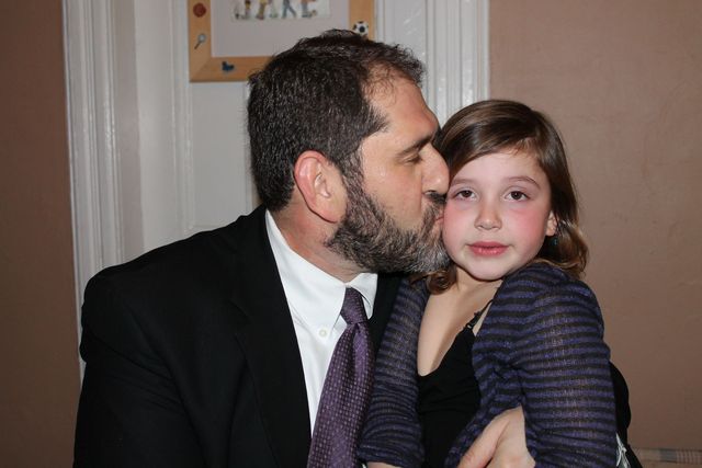 <p>Craig Treitler kisses his daughter Ella, 5. The family loves having an au pair.&nbsp;</p>
