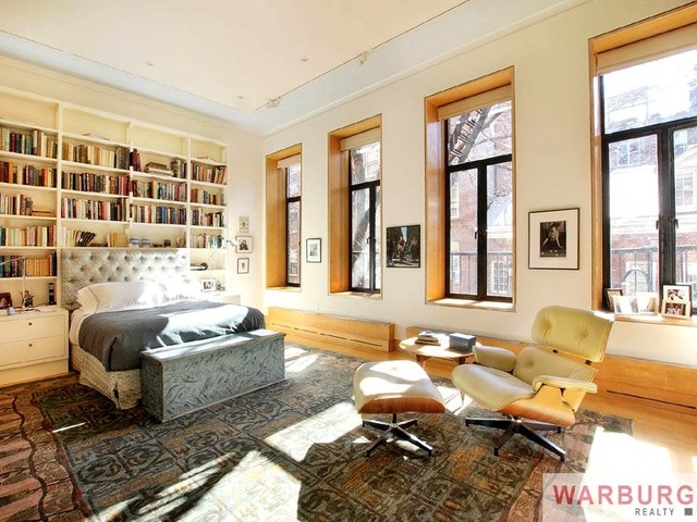 <p>The master bedroom has built-in bookshelves and end tables.</p>
