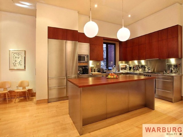 <p>The home's kitchen features dark wood and stainless steel.</p>

