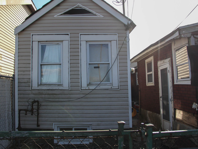 <p>The home at 776 New Dorp Lane has been abandoned for years, neighbors said. Neighbors fear the home could collapse due to a gaping crack in the back concrete wall, which they say has gotten worse since Superstorm Sandy. March 5, 2013.</p>

