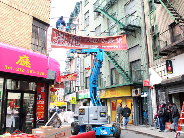<p>Film crews string banners over Doyers Street ahead of filming for "The Amazing Spider-Man 2."</p>
