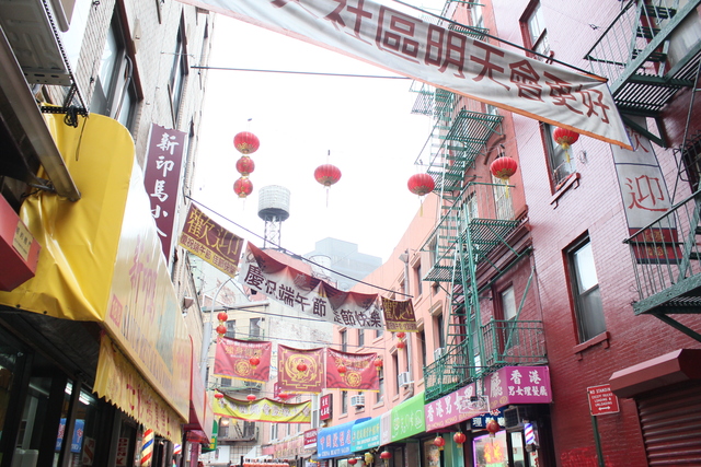 <p>Film crews string banners over Doyers Street ahead of filming for "The Amazing Spider-Man 2."</p>
