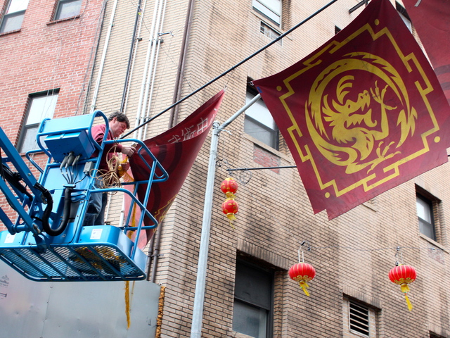 <p>Film crews string banners over Doyers Street ahead of filming for "The Amazing Spider-Man 2."</p>
